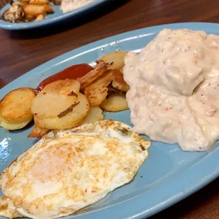À la carte - half order of biscuits and gravy, fried potatoes, and an over medium egg.