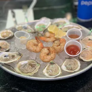 a platter of oysters and shrimp