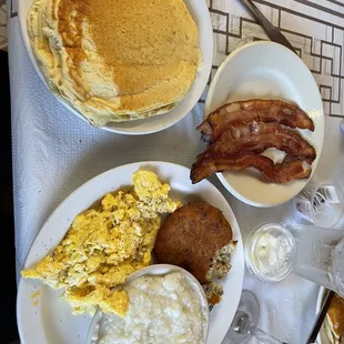 a breakfast of pancakes, eggs, bacon, and pancakes