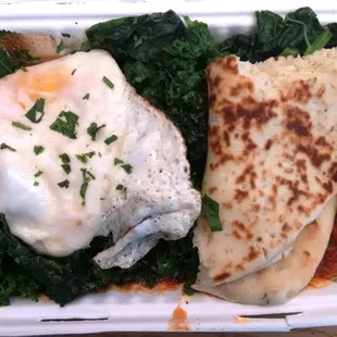 Shakshuka | Tomato sauce w/ chorizo, bed of kale, fried egg &amp; flatbread