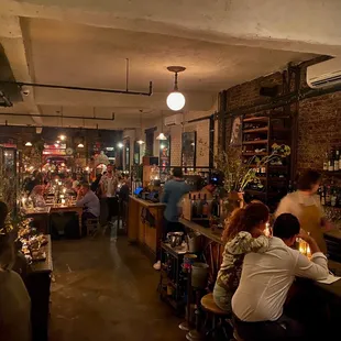 a crowded bar with people sitting at the bar