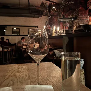 a glass of wine on a table in a restaurant