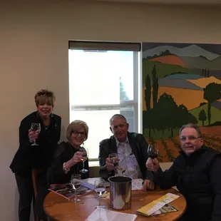 a group of people drinking wine