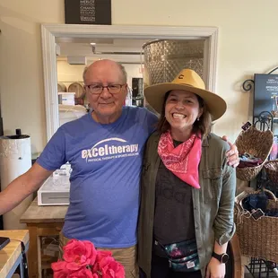 a man and a woman standing in a tasting room
