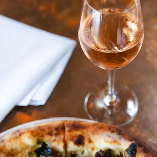 a pizza and a glass of wine