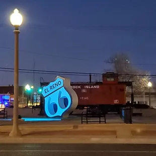 a blue route 66 sign on a street corner