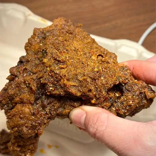 a hand holding a piece of food