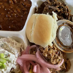 Pecos platter: pulled pork, beef brisket, baked potatoes salad, roll, and Pecos spicy baked beans