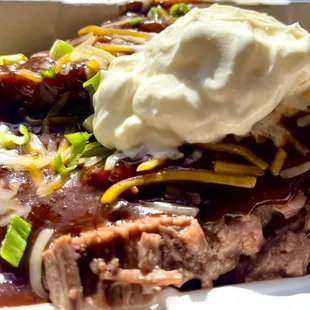 My regular - beef brisket sliced on sweet potato with all the toppings and medium sauce