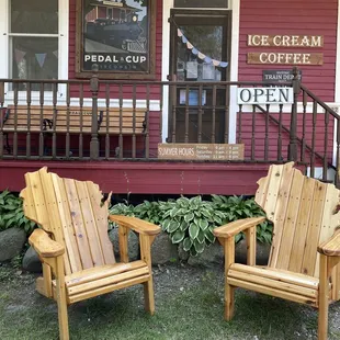 two adiron chairs outside of a building