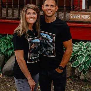 a man and a woman in matching t - shirts