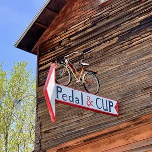 a bicycle mounted on the side of a building