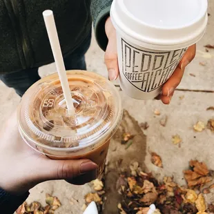 a person holding a cup of coffee