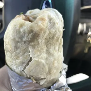 a hand holding a burrito
