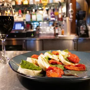 a plate of food and a glass of wine