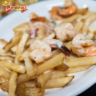 a plate of fries and shrimp