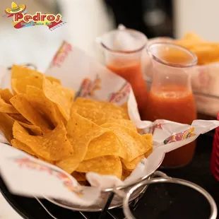 a tray of chips and salsa