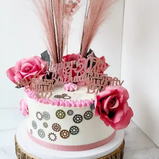 a birthday cake with pink flowers