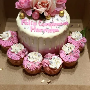 a birthday cake and cupcakes