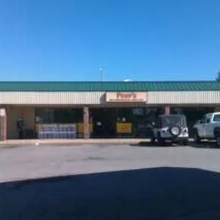 two trucks parked in front of a store