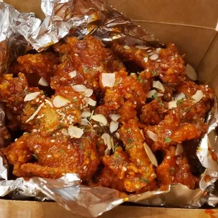 a box of chicken wings and a bowl of dip