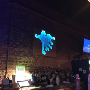 a bar with a neon sign above the bar