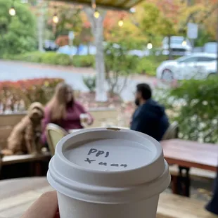 a person holding a cup of coffee