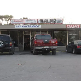three cars parked in front of a restaurant