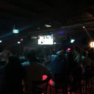 a group of people sitting at a bar