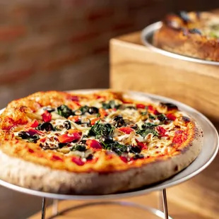 two pizzas on a table