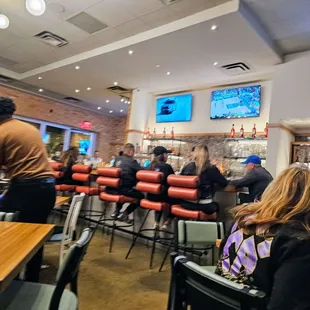 people sitting at tables in a restaurant