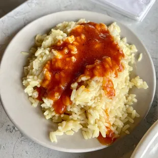 Side of rice pilaf with extra sauce.
