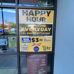 a happy hour sign in front of a restaurant