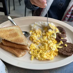 Two eggs and sausage with grits
