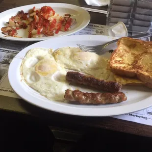 Eggs sausage French toast and home fries.