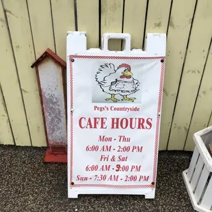 a sign for the cafe hours