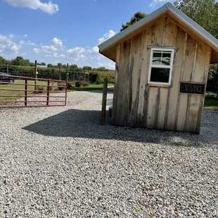 a small wooden building with a window