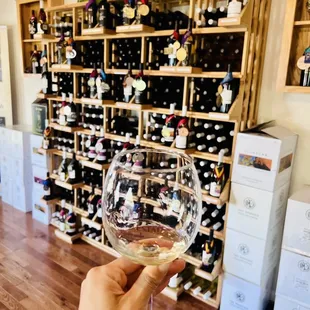 a hand holding a glass of wine