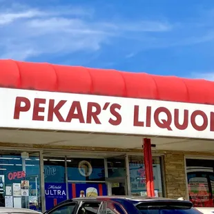 cars parked in front of a liquor store