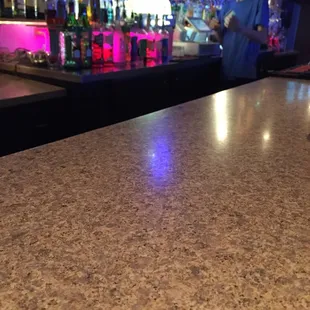 a woman behind a bar counter