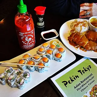 plates of sushi, chopsticks and sauce