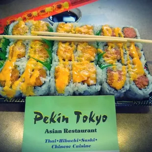 a plate of sushi and chopsticks