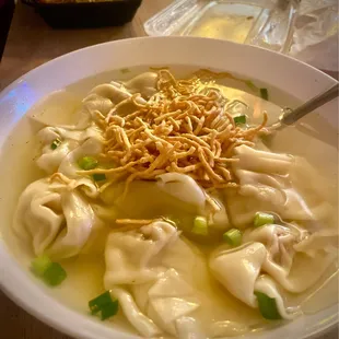 a bowl of soup with dumplings