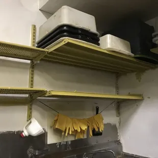 a kitchen with a sink and shelves