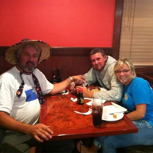 three people sitting at a table