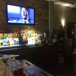 a man sitting at a bar watching tv