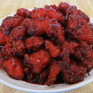 a white bowl of food on a wooden table