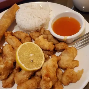 a plate of fried food with a side of dipping sauce