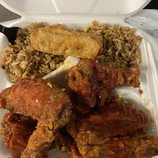 Chicken wings fried hard. Fried rice and egg roll. I put hot sauce, ketchup, and chili oil on my chicken.