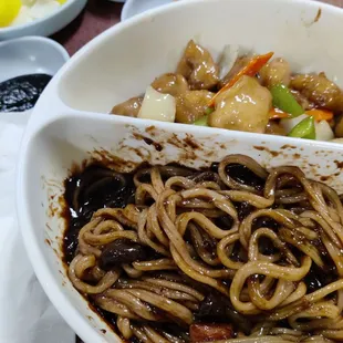 a bowl of noodles with chopsticks